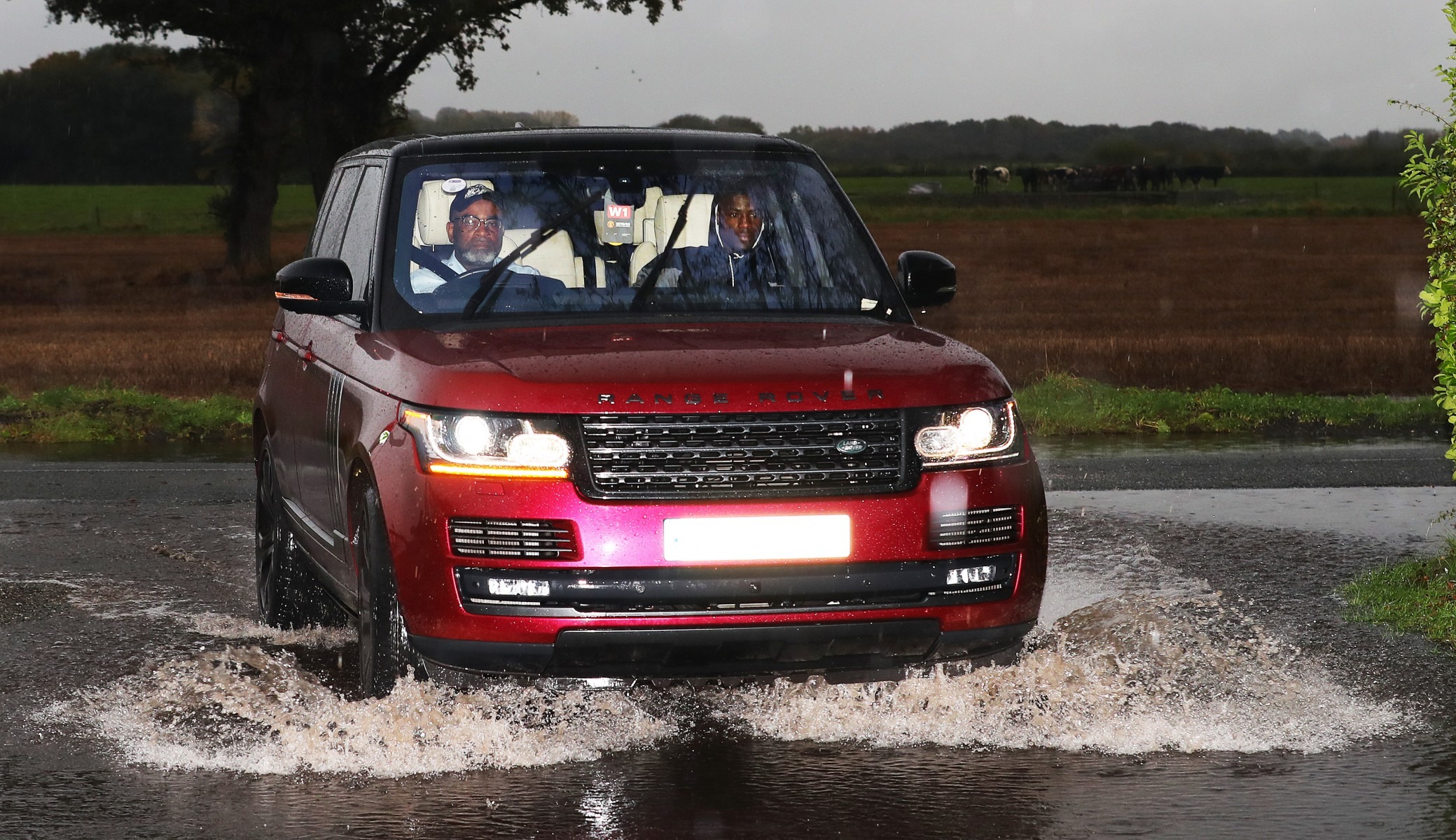 , Man Utd stars drive through pouring rain and huge puddles into Carrington to prepare for Norwich clash