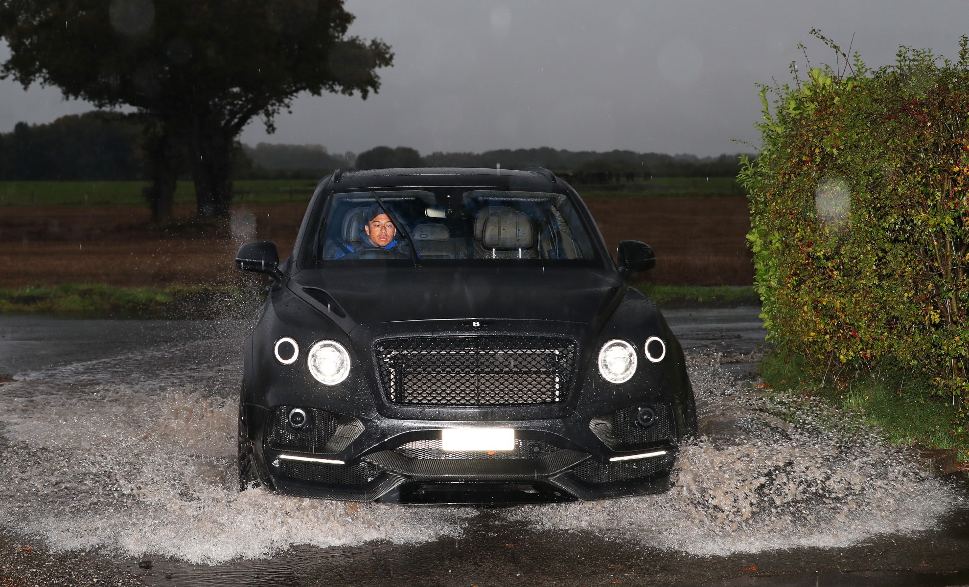 , Man Utd stars drive through pouring rain and huge puddles into Carrington to prepare for Norwich clash