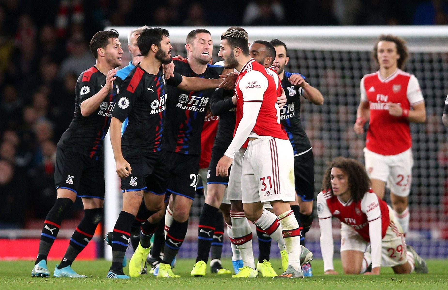 , Arsenal star Guendouzi somehow escapes red card as rugby tackle on Zaha starts brawl vs Palace