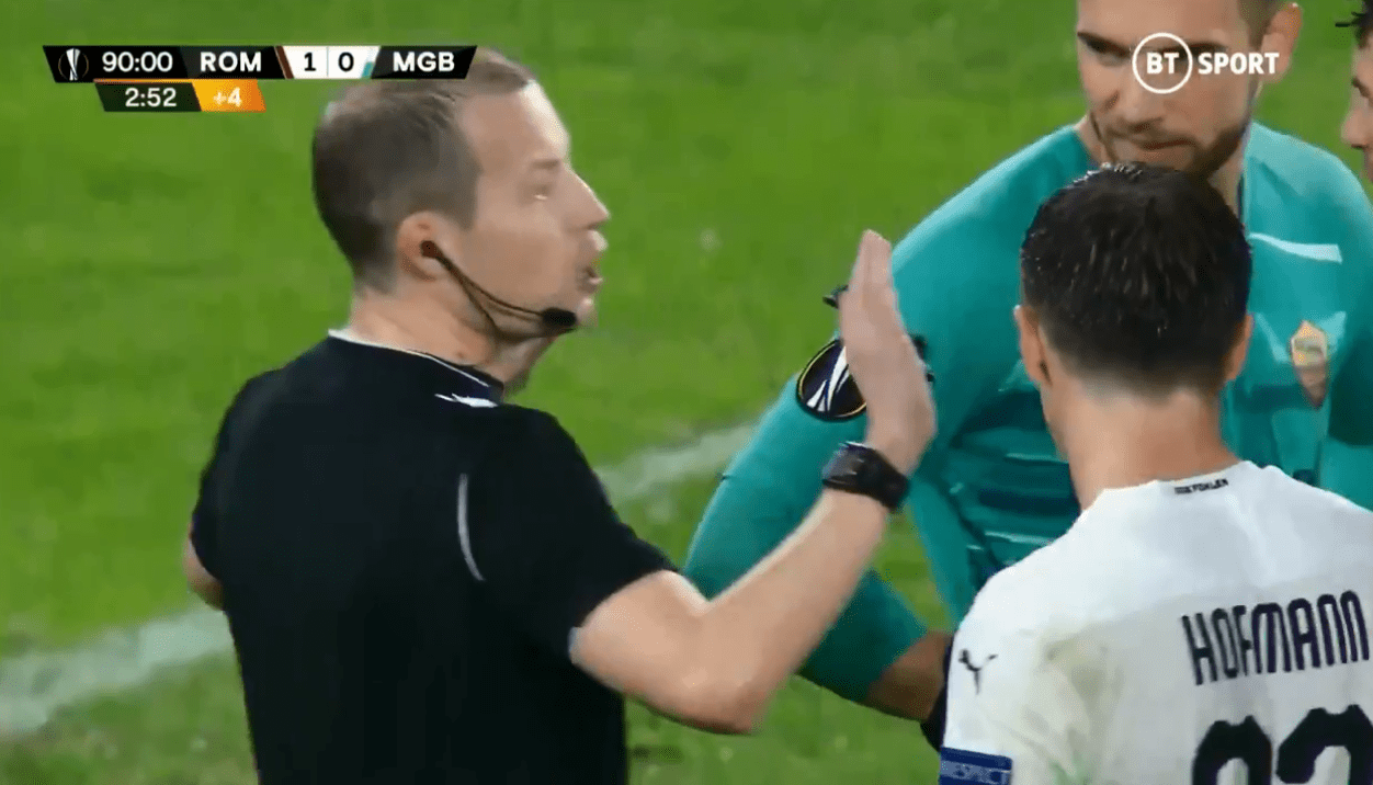 Referee William Collum shrugs off Roma protests as he awards a a shocking penalty against Chris Smalling