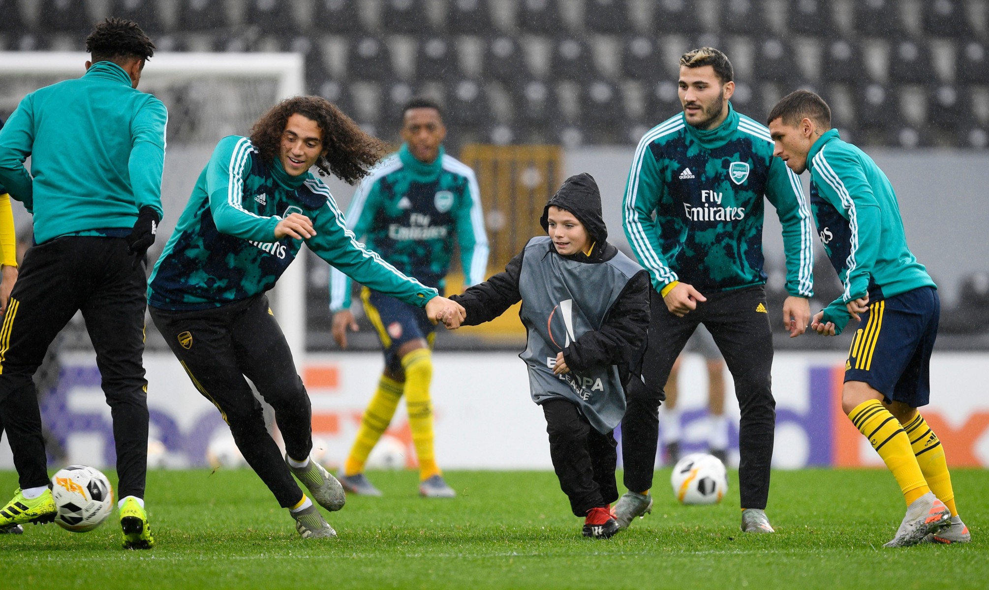 , Watch the heartwarming moment Arsenal star Guendouzi holds mascots hand as child takes part in training session