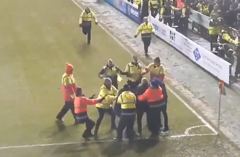 , Watch shocking scenes as rival Blackpool and Fleetwood fans fight on the pitch in the League One clash