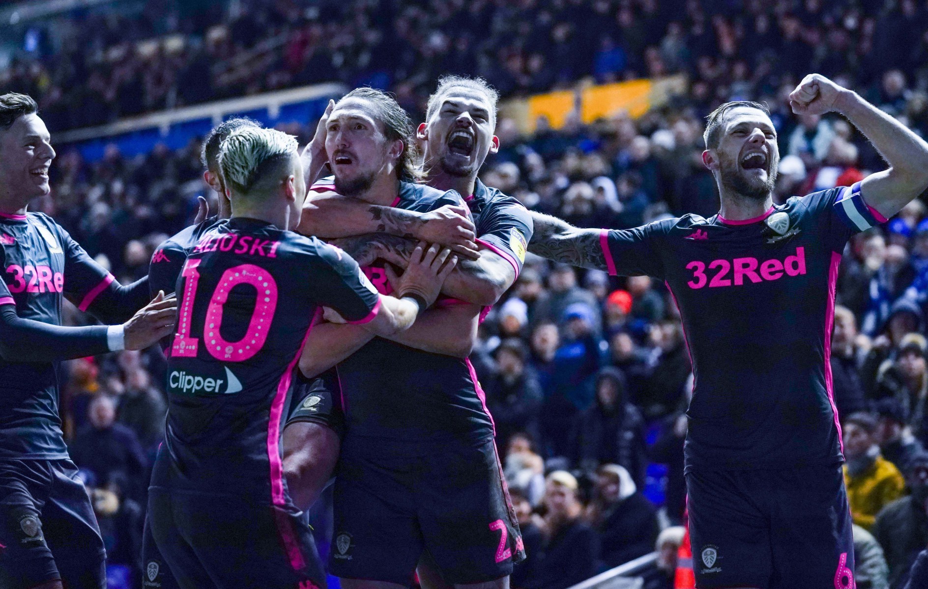 Leeds celebrate their thrilling late win at Birmingham which saw them climb to the top of the Championship