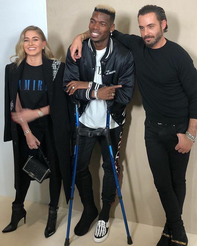 , Injured Paul Pogba attends Paris fashion show on crutches with partner Zulay while Man Utd gear up for Liverpool