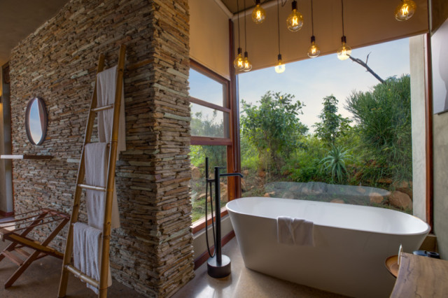 Bathrooms each feature huge windows so you can see all the wildlife as you bathe