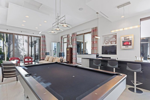 The £9.5m property had a games room with giant pool table that flowed out onto the patio