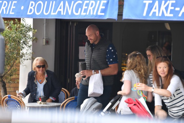 , Tyson Fury smiles as he leaves coffee shop while wife Paris waits for boxing world champ in Rolls-Royce