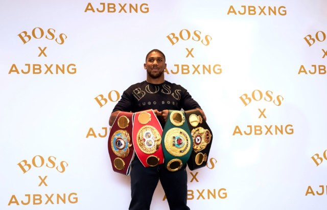 , Anthony Joshua and Maya Jama joke around at Hugo Boss event with boxing champ’s four world title belts on display