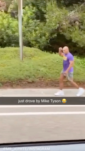 , Mike Tyson stuns fan by training on side of the road with car in tow ahead of his comeback against Roy Jones Jr