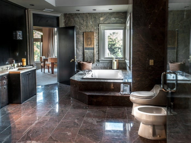 This bathroom features a huge bathtub overlooking the gardens