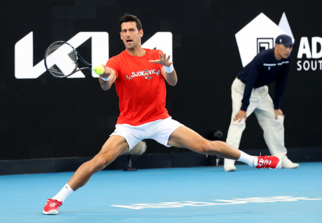 , Topless Novak Djokovic jokes around on beach in his shorts as tennis star prepares for Australian Open after quarantine