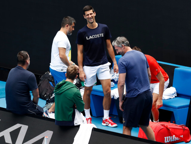 , Topless Novak Djokovic jokes around on beach in his shorts as tennis star prepares for Australian Open after quarantine