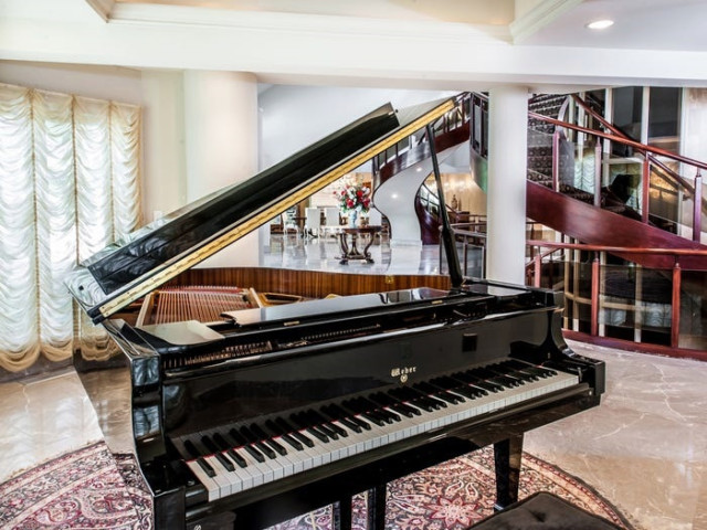 The reception room features a Weber grand piano