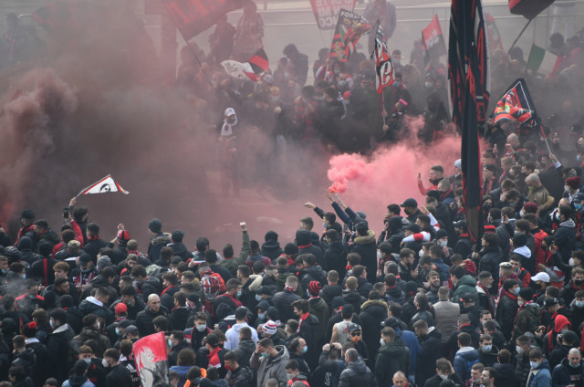 , AC Milan and Inter fans light flares as they gather outside San Siro ahead of behind-closed-doors derby