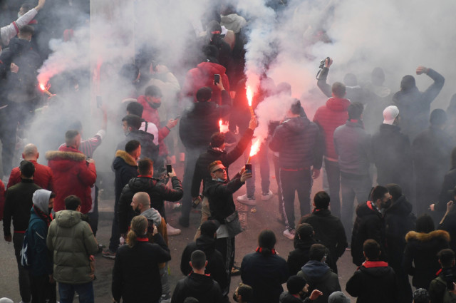 , AC Milan and Inter fans light flares as they gather outside San Siro ahead of behind-closed-doors derby
