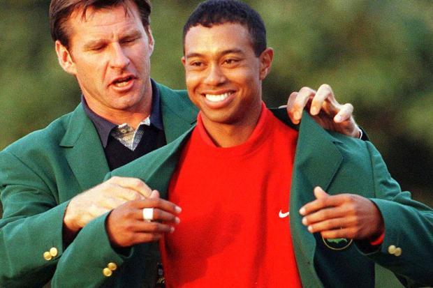 Tiger gets his first Green Jacket from Faldo in 1997
