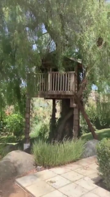 A treehouse sits in the garden of the property