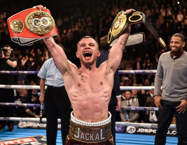 Carl Frampton celebrates with the IBF and WBA Super-Bantamweight belts after defeating Scott Quigg last year
