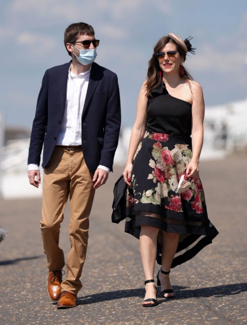 , Beaming racegoers arrive dressed to the nines for Epsom Derby Day – even matching facemasks to their outfits