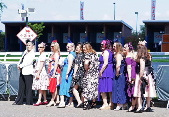 , Beaming racegoers arrive dressed to the nines for Epsom Derby Day – even matching facemasks to their outfits