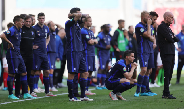 , Heartwarming moment Finland fans hand over their country’s flags to shield stricken Denmark star Christian Eriksen