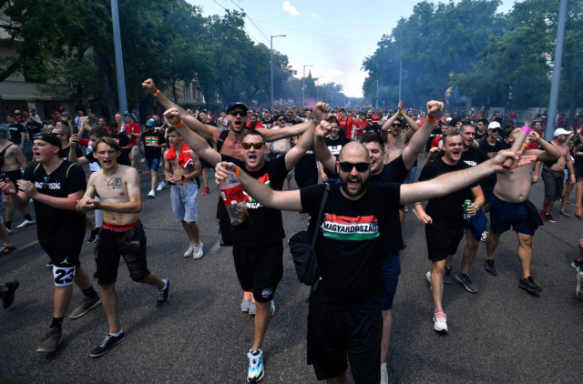 , Hungary fans hold anti-kneeling banner and set off flares as thousands march in Budapest before Euro 2020 France clash