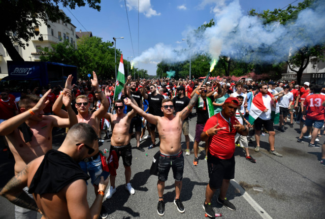, Hungary fans hold anti-kneeling banner and set off flares as thousands march in Budapest before Euro 2020 France clash