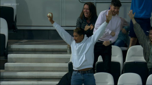 , Cricket fan dives over seats to catch ball before necking his pint
