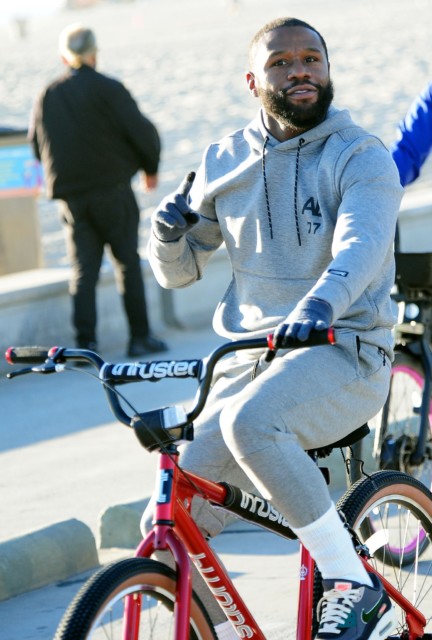 , Floyd Mayweather spotted on bike ride along beach in LA as 44-year-old keeps fit after boxing return