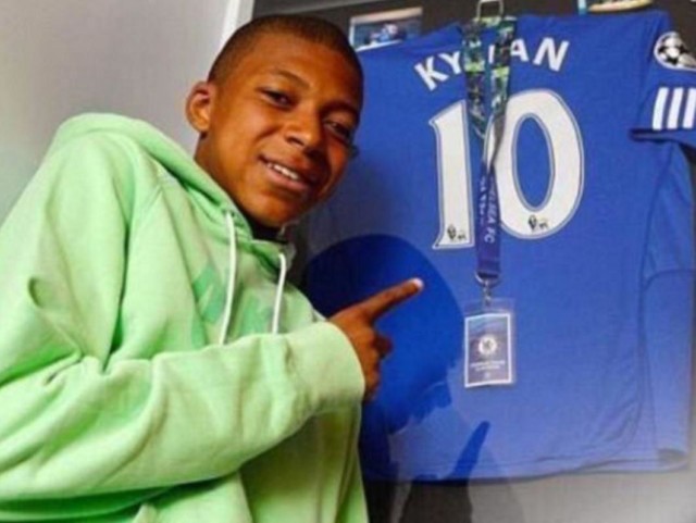 Kylian Mbappe poses with a personalised Chelsea shirt featuring his first name