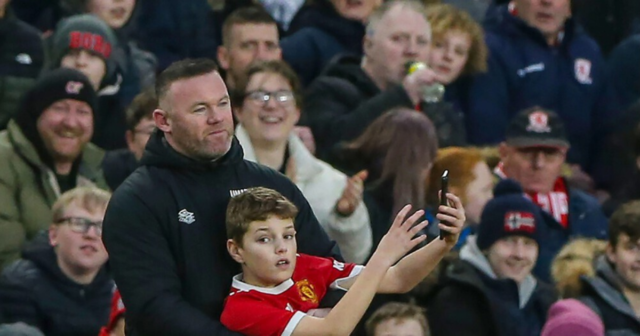 , Man Utd legend Wayne Rooney poses for selfie with brazen pitch invader as young fan sprints up wing to dodge stewards