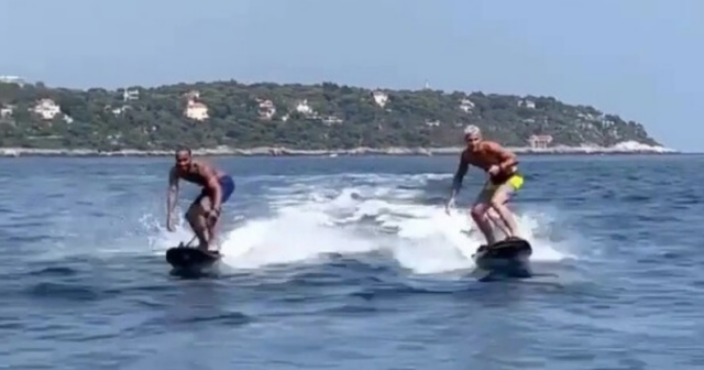 , Topless Lewis Hamilton starts his summer F1 break by hitting waves on £20,000 electric jet-surfboard