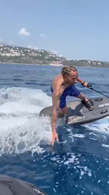, Topless Lewis Hamilton starts his summer F1 break by hitting waves on £20,000 electric jet-surfboard