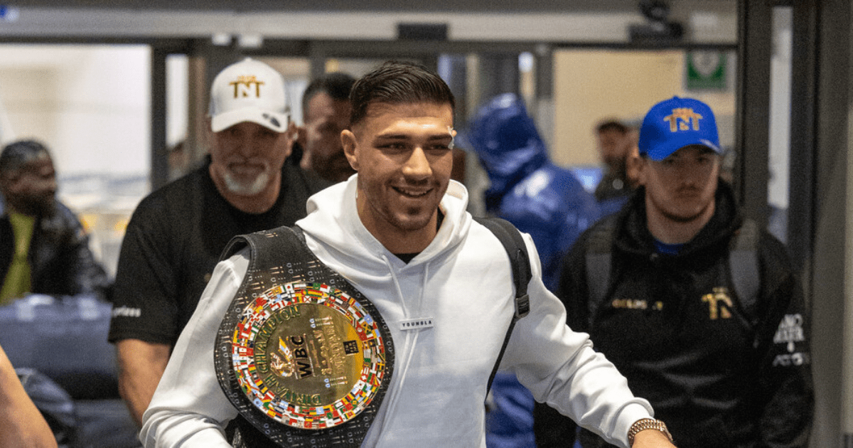 , Bruised Tommy Fury beams as he touches down at Heathrow with brother Tyson and dad John after huge win over Jake Paul