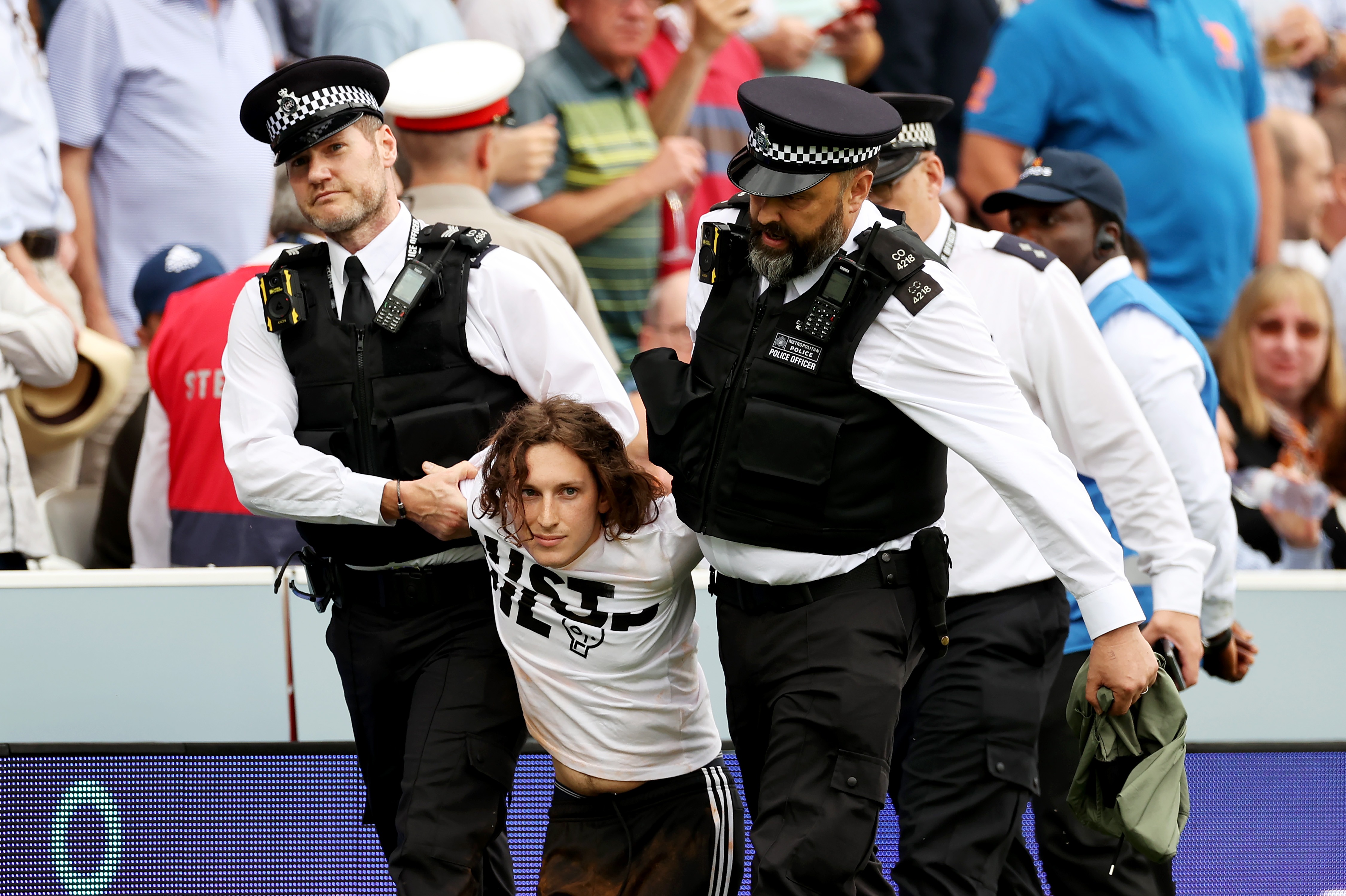 LONDON, ENGLAND - JUNE 28: A "Just Stop Oil" protester is taken away by Police officers during Day One of the LV= Insurance Ashes 2nd Test match between England and Australia at Lord's Cricket Ground on June 28, 2023 in London, England. (Photo by Ryan Pierse/Getty Images)