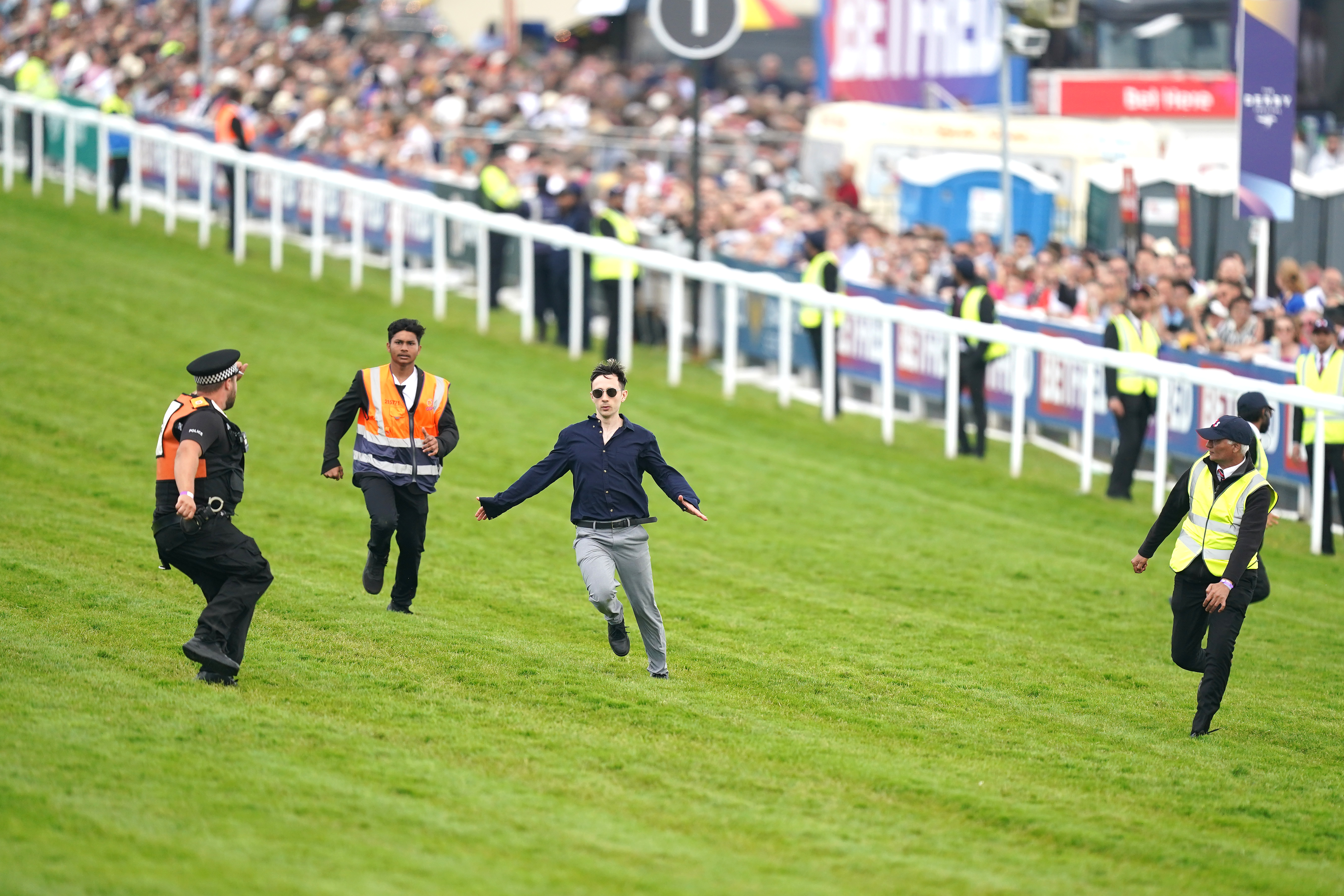 , Protestor sprinting on Epsom Derby racecourse tackled as animal activists’ plot to disrupt race is foiled