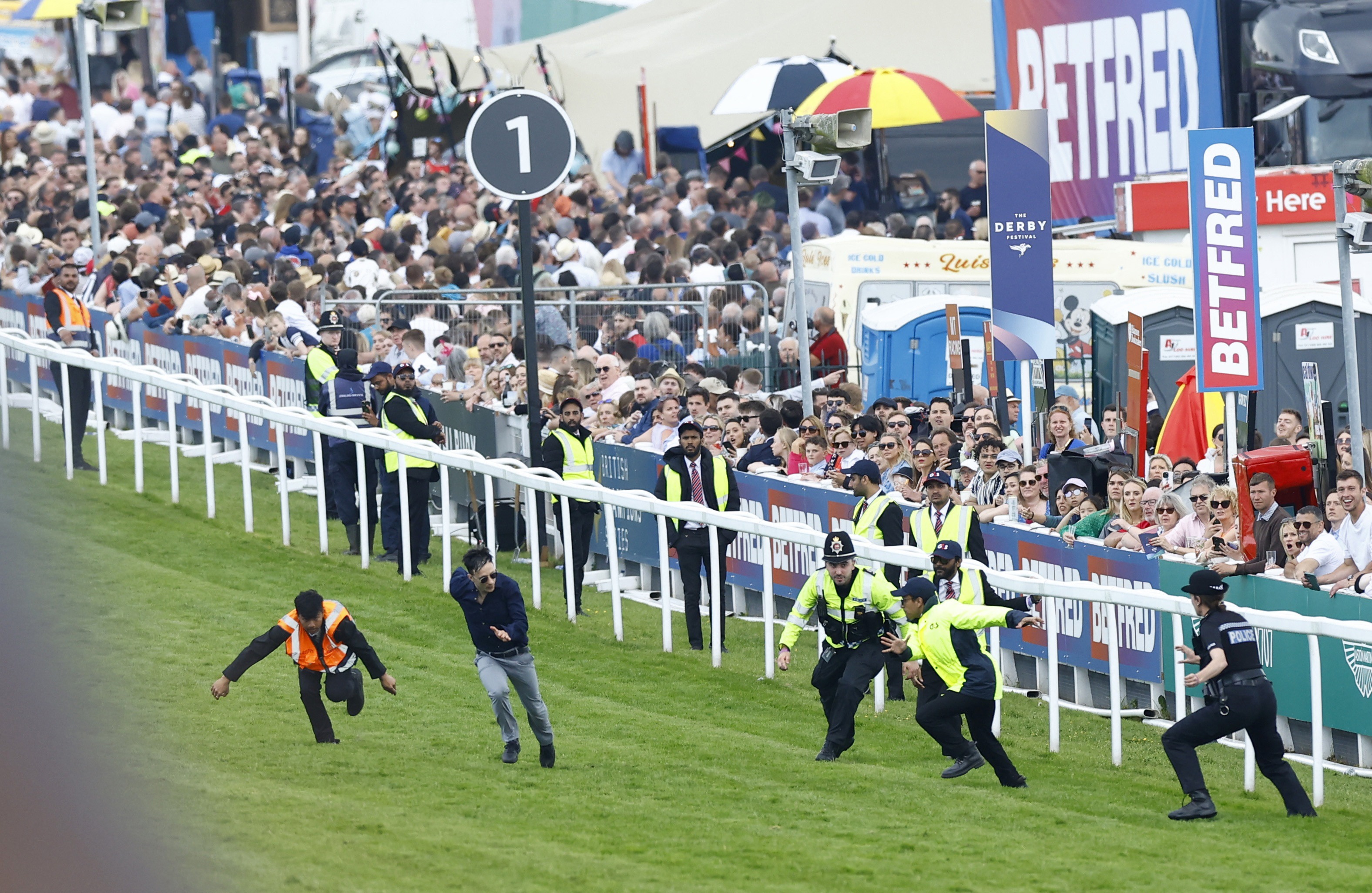 , Protestor sprinting on Epsom Derby racecourse tackled as animal activists’ plot to disrupt race is foiled