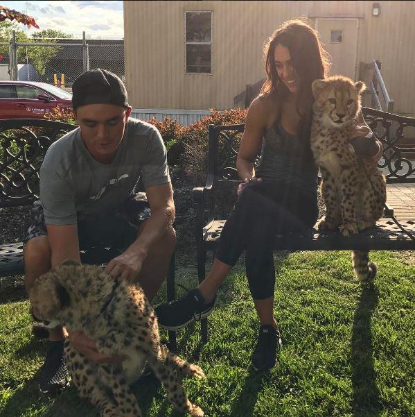 Rickie and Allison pose with two leopards at Columbus Zoo